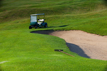 Image showing Green golf cart on the empty golf course