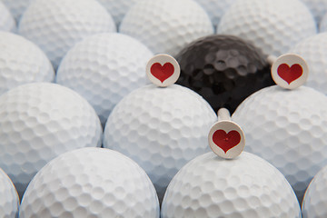 Image showing Different golf balls and romantic tees