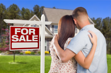 Image showing For Sale Real Estate Sign, Military Couple Looking at House