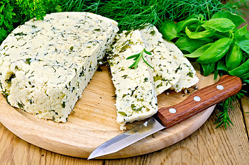 Image showing Cheese round homemade with condiments and a knife