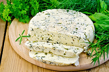 Image showing Cheese round homemade with herbs chopped