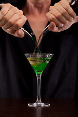 Image showing Bartender pours drink