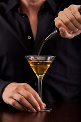 Image showing Bartender pours drink