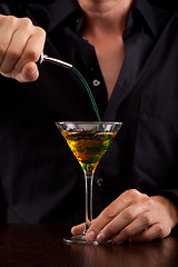 Image showing Bartender pours drink