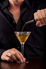 Image showing Bartender pours drink