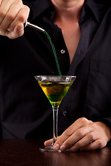 Image showing Bartender pours drink