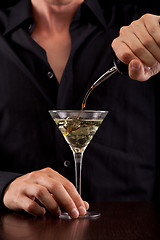 Image showing Bartender pours drink