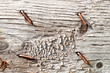 Image showing textured surface of board with a rusty nail