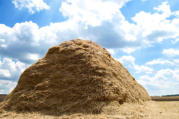 Image showing stack of straw on a background blue sky with clouds