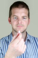 Image showing Man holding a Pill