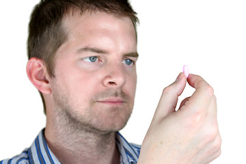 Image showing Man holding a Pill