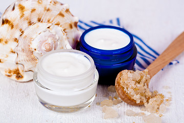 Image showing face cream in jars with sea salt and shell 