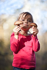 Image showing Little girl with mushrooms