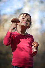 Image showing Little girl with mushrooms