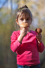 Image showing Little girl with mushrooms