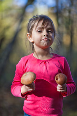 Image showing Little girl with mushrooms