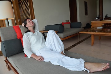 Image showing happy young woman relax at home on sofa