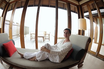 Image showing happy young woman relax at home on sofa