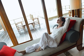 Image showing happy young woman relax at home on sofa