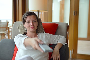 Image showing happy young woman relax at home on sofa