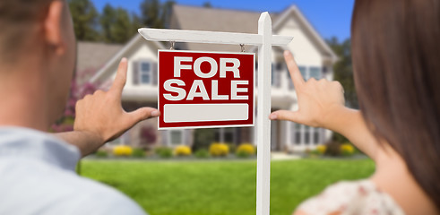 Image showing For Sale Sign, House and Military Couple Framing Hands