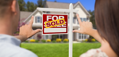 Image showing Sold For Sale Sign, House and Military Couple Framing Hands