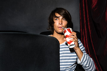 Image showing Man Drinking Soda In Cinema Theatre