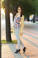 Image showing Pretty brunette in grey jeans