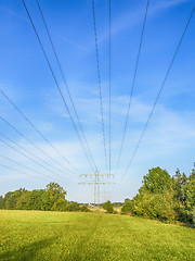 Image showing Power calbe over green meadow