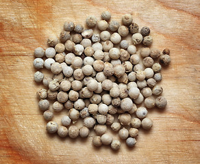 Image showing white pepper macro on wooden board