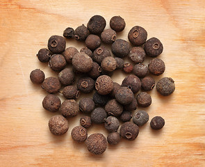 Image showing pimento peppercorns macro on wooden board