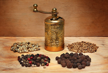 Image showing grinder and spices on a wooden board