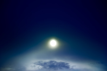 Image showing Bright shine through night sky with clouds