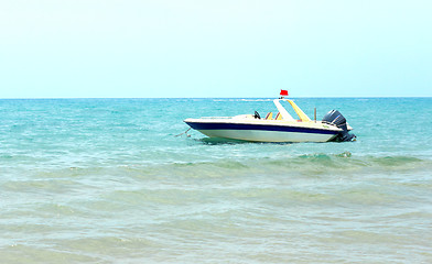 Image showing A pleasure boat in the coastal waters near the beach.