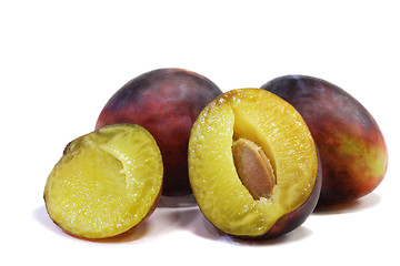 Image showing Large ripe plums on a white background.