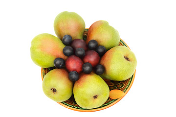 Image showing Pears, plums and prunes on the plate on a white background.