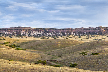 Image showing rolling prairie and cliff