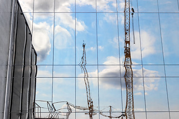 Image showing Construction cranes reflecting in a modern building