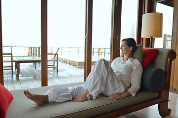 Image showing happy young woman relax at home on sofa