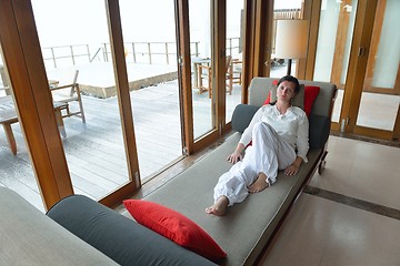 Image showing happy young woman relax at home on sofa