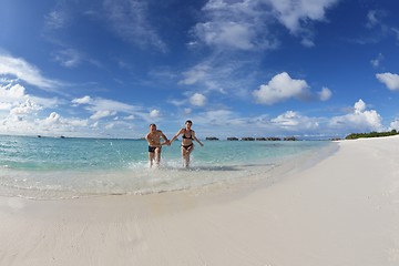 Image showing happy young couple have fun on beach