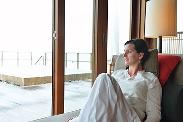 Image showing happy young woman relax at home on sofa