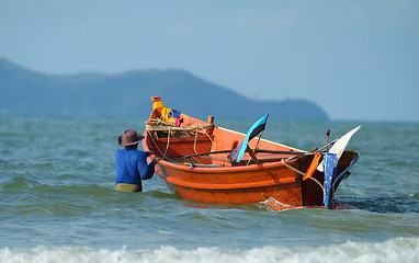 Image showing Fisherman taking his boat to sea