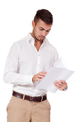 Image showing young adult businessman reading document letter isolated