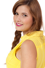 Image showing smiling young brunette woman in yellow dress isolated