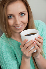 Image showing smiling young woman drinking coffee