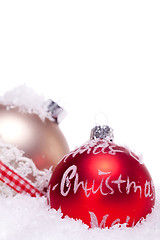 Image showing christmas decoration festive red bauble in snow isolated