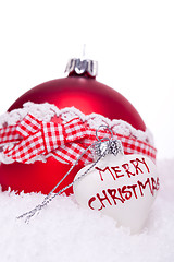 Image showing christmas decoration festive red bauble in snow isolated