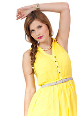 Image showing smiling young brunette woman in yellow dress isolated