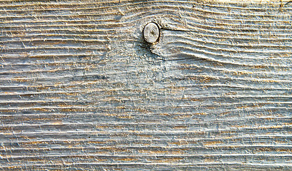 Image showing textured surface of board with a twig